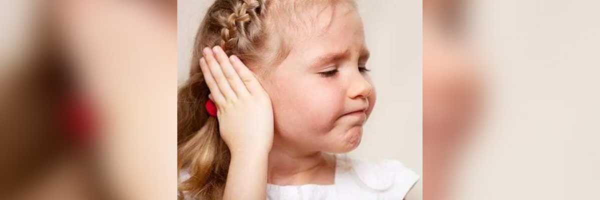 little girl covering her ear
